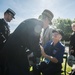 Officials shake hands with World War II veterans