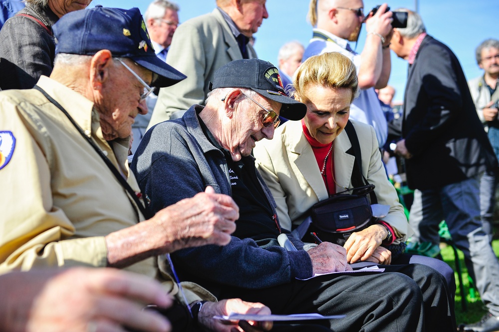 World War II veteran signs an autograph