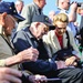 World War II veteran signs an autograph