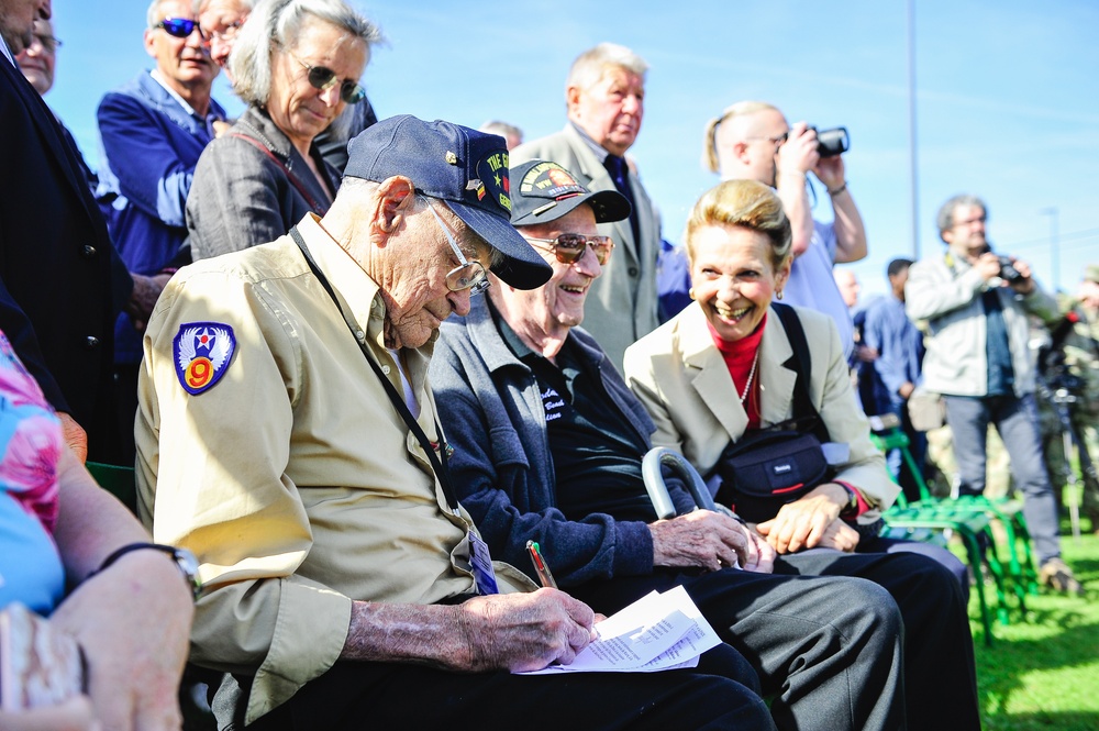 World War II veteran signs autograph