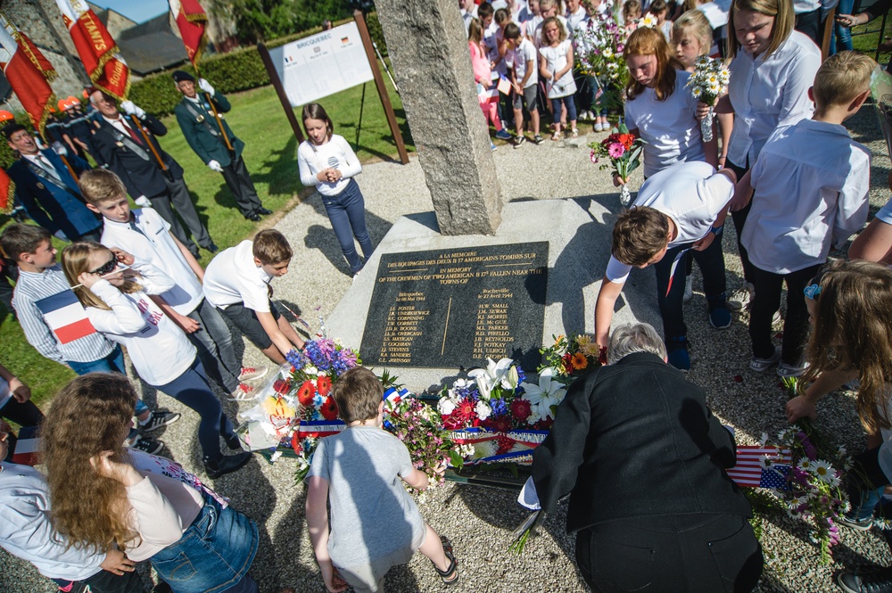 Children offer flowers and flags