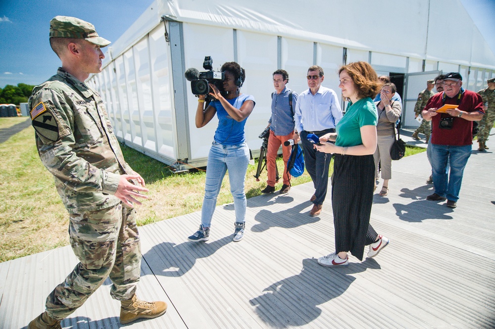 Soldier leads media through logistics area