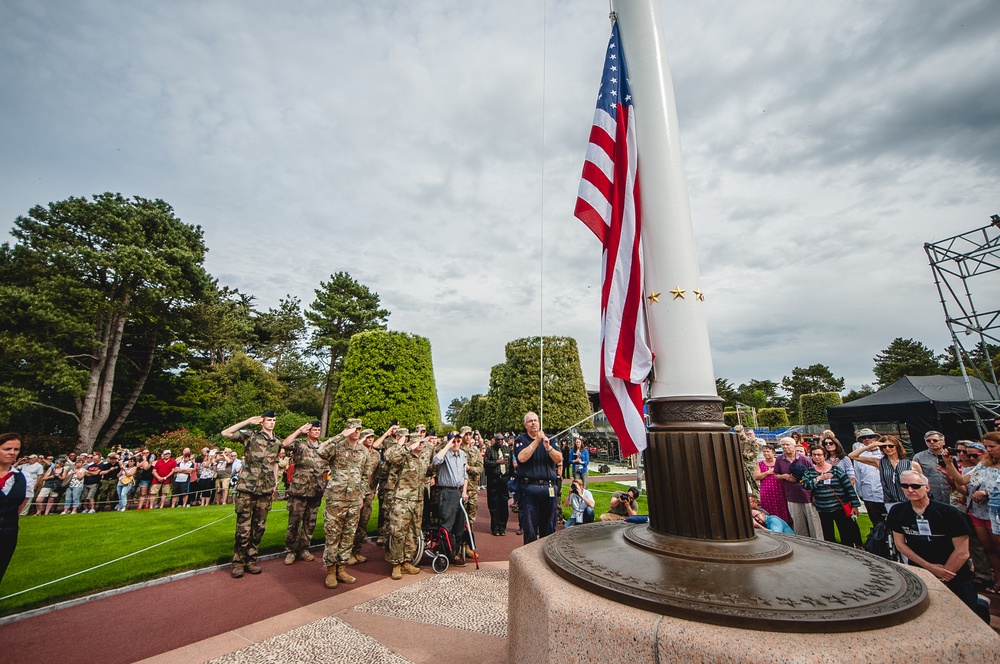 Crowd gathers for lowering of flag