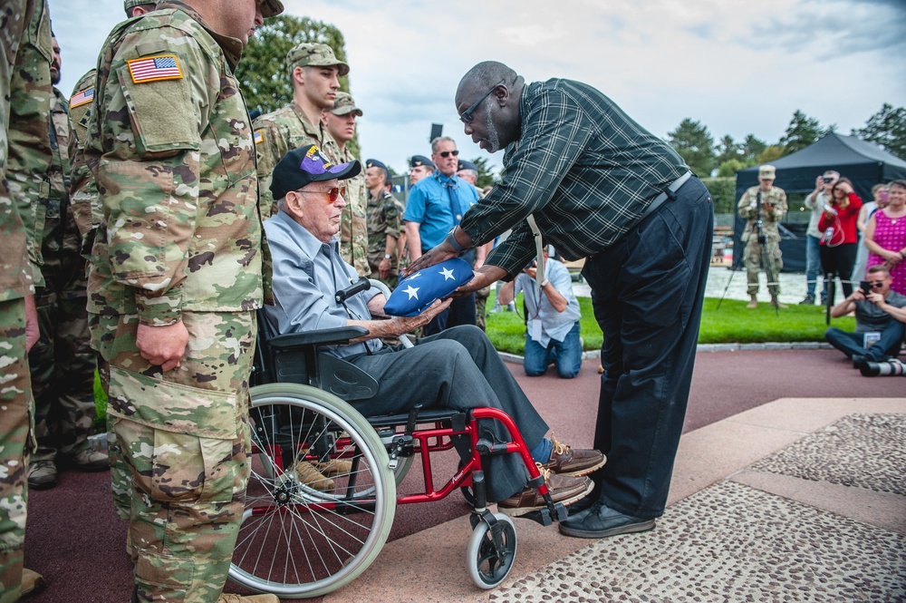 Staff at Cemetery present Flag to World War II Veteran