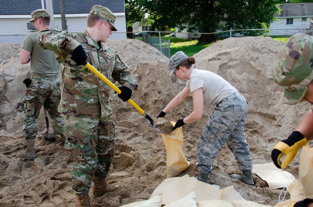 Airmen fill sand bags for flood fighting