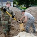 Airmen fill sand bags for flood fighting