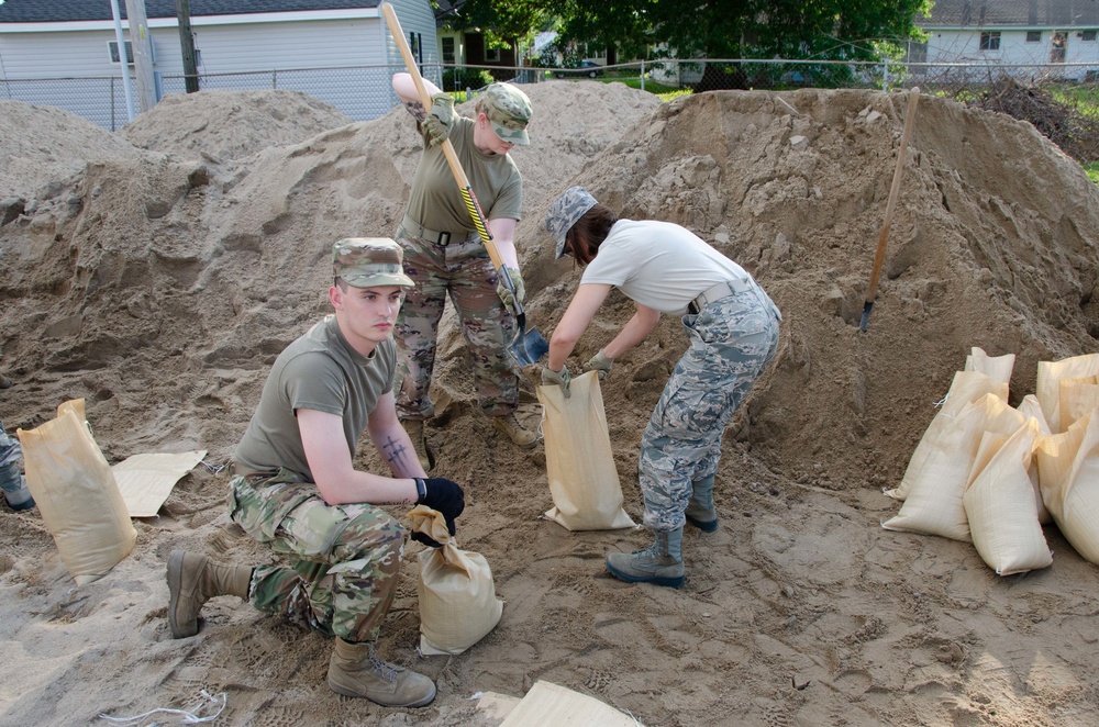 Airmen fill sand bags for flood fighting