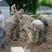 Airmen fill sand bags for flood fighting