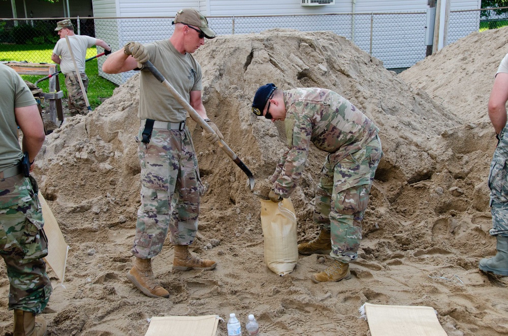 Airmen fill sand bags for flood fighting