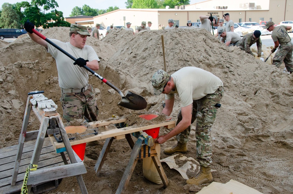 Airmen fill sand bags for flood fighting