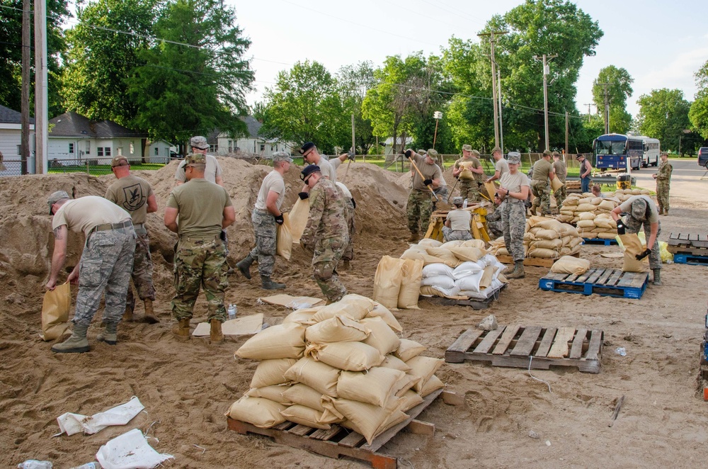 Airmen fill sand bags for flood fighting