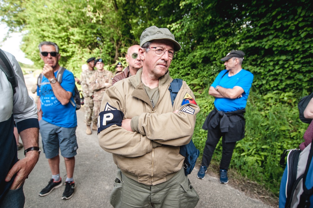 Tourist Listens Closely During Tour in Picauville