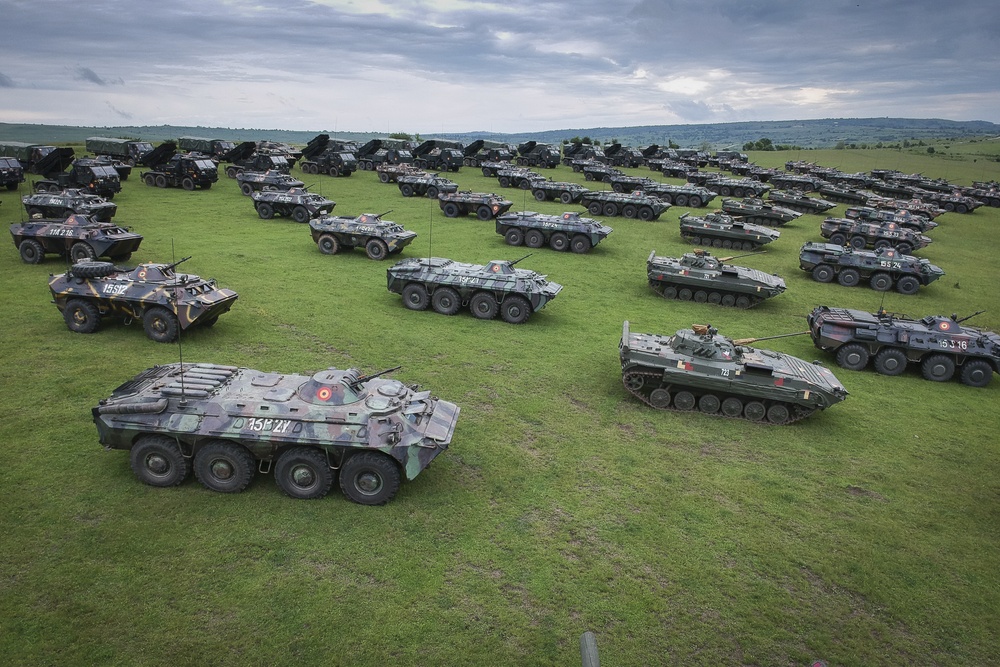 A static display of Romanian Land Force vehicles are staged in the background of the opening ceremony of Saber Guardian 2019