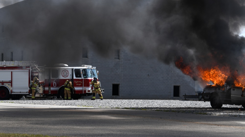 Firefighters put out car fires during Exercise Global Dragon 2019