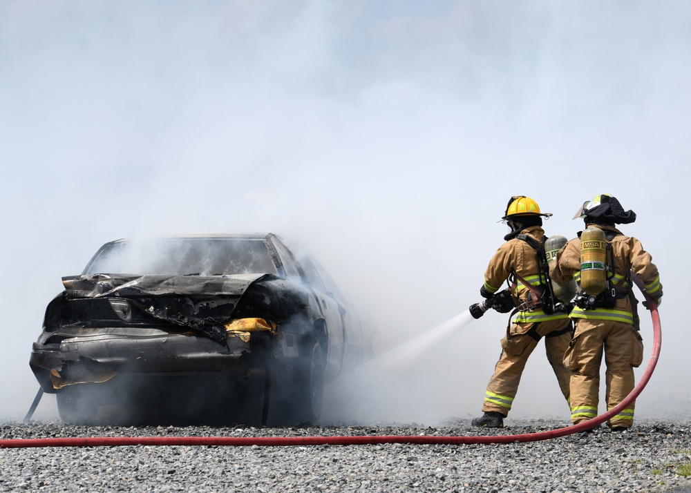 Firefighters put out car fires during Exercise Global Dragon 2019