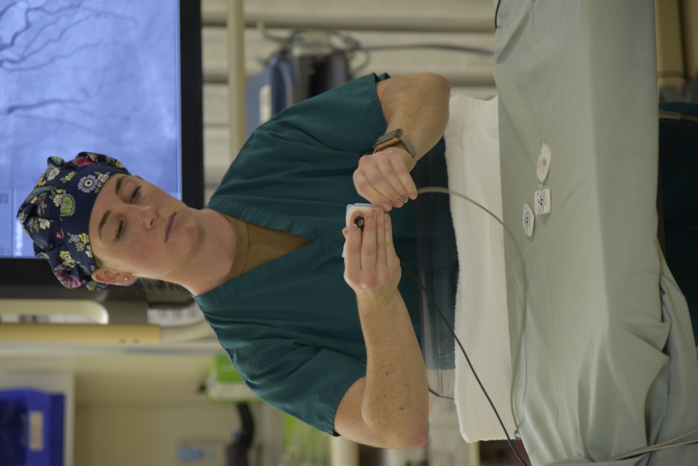 A Walter Reed Bethesda cardiovascular technician prepares a cath lab for a procedure