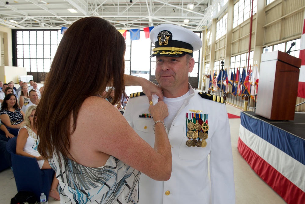 Cmdr. Michael P. Bukolt, Jr.'s wife pins the Command at Sea pin