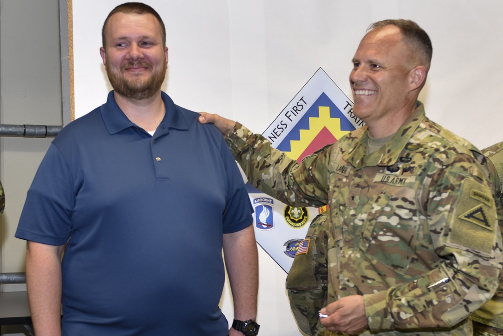 Brandon Tillery receives coin at the summer exercises command.