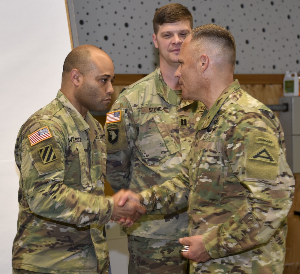 Capt. James Williamson receives coin at the summer exercises command.