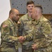 Capt. James Williamson receives coin at the summer exercises command.
