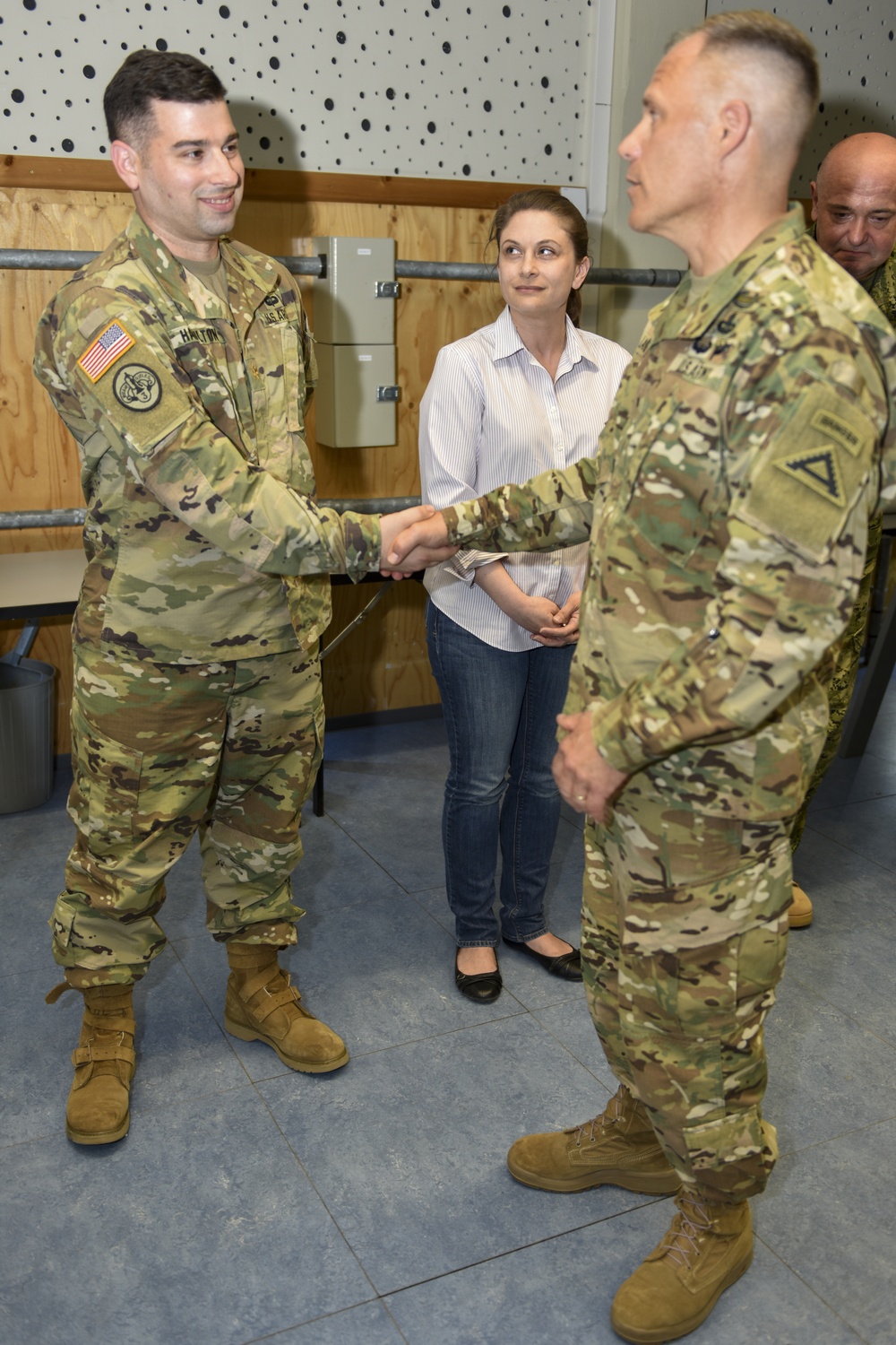 Maj. Erik Hamilton receives coin at the summer exercises command.