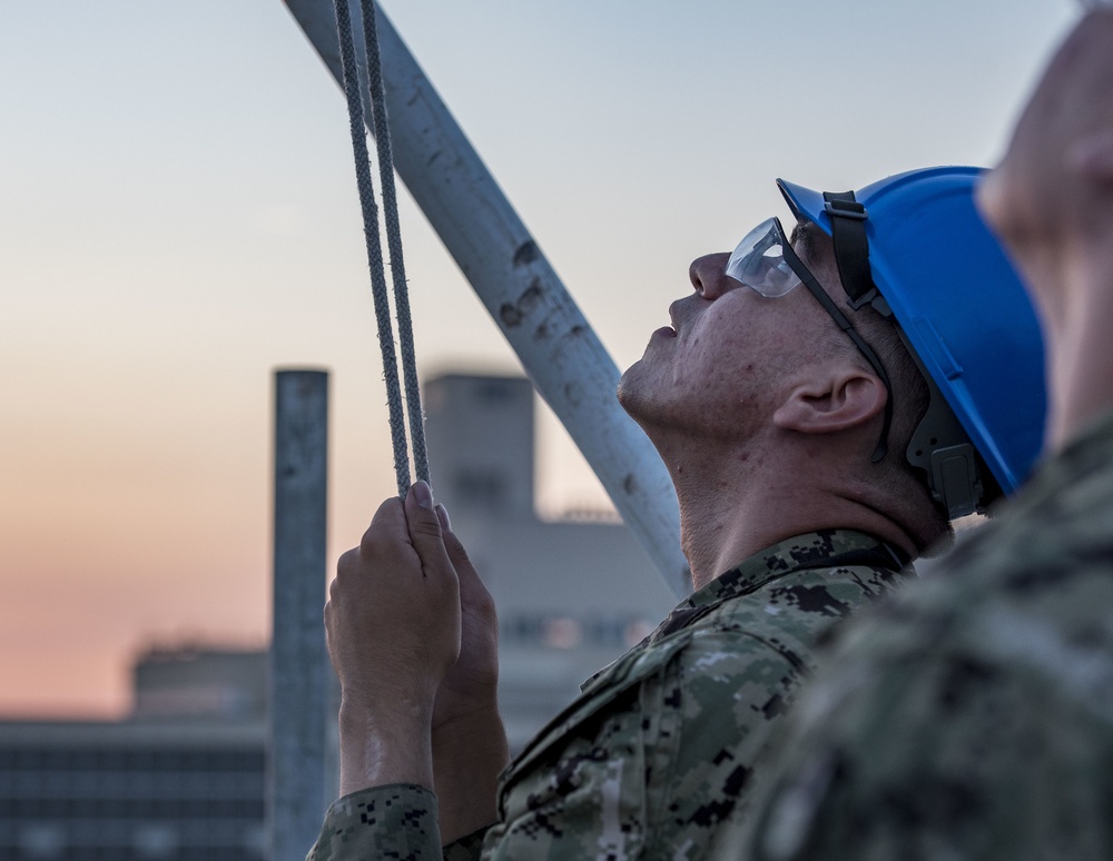 Sailors lower First Navy Jack