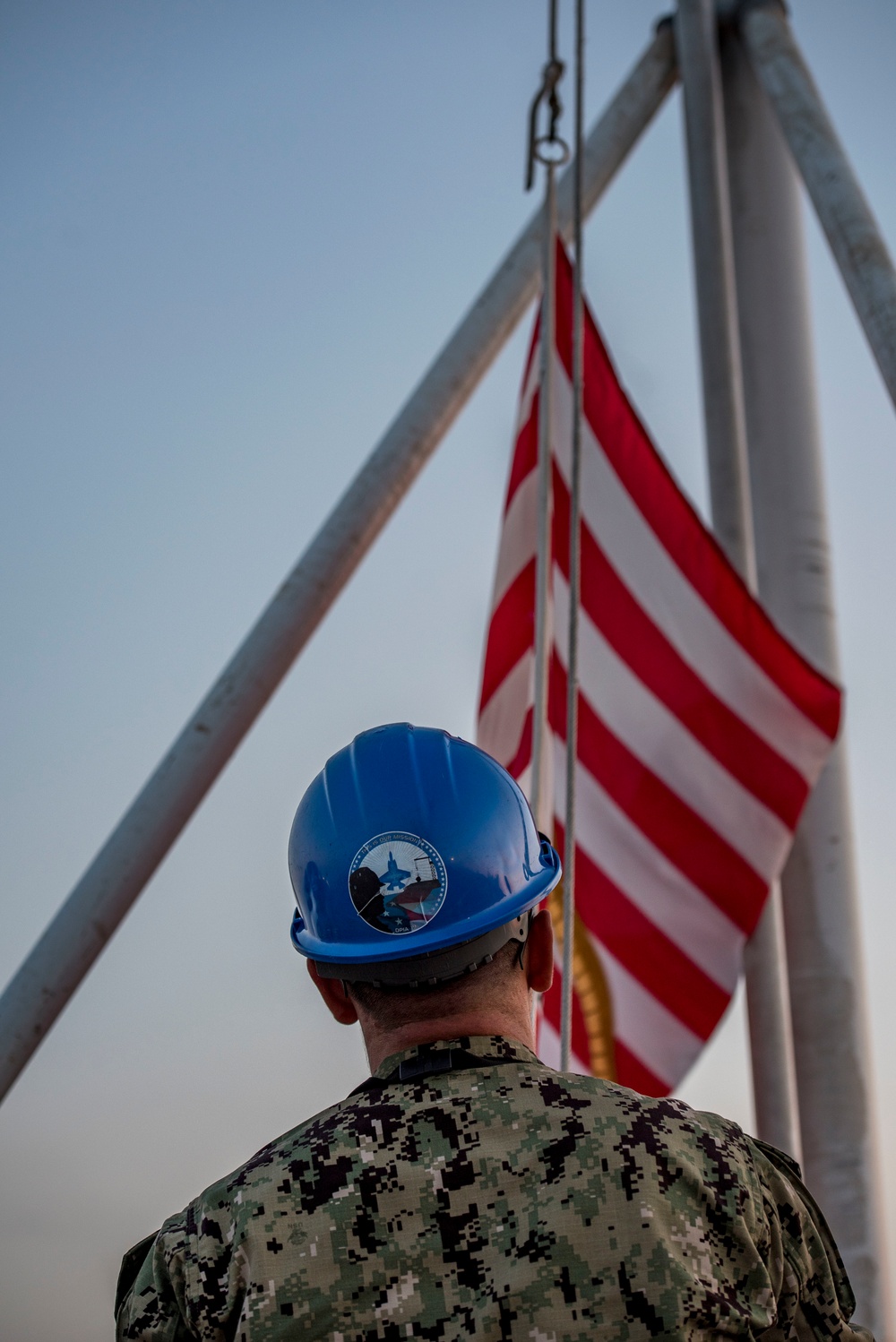 Sailor Lowers First Navy Jack