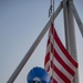 Sailor Lowers First Navy Jack