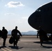 Members of the 306th Rescue Squadron board a C-17 Globemaster, headed for deployment