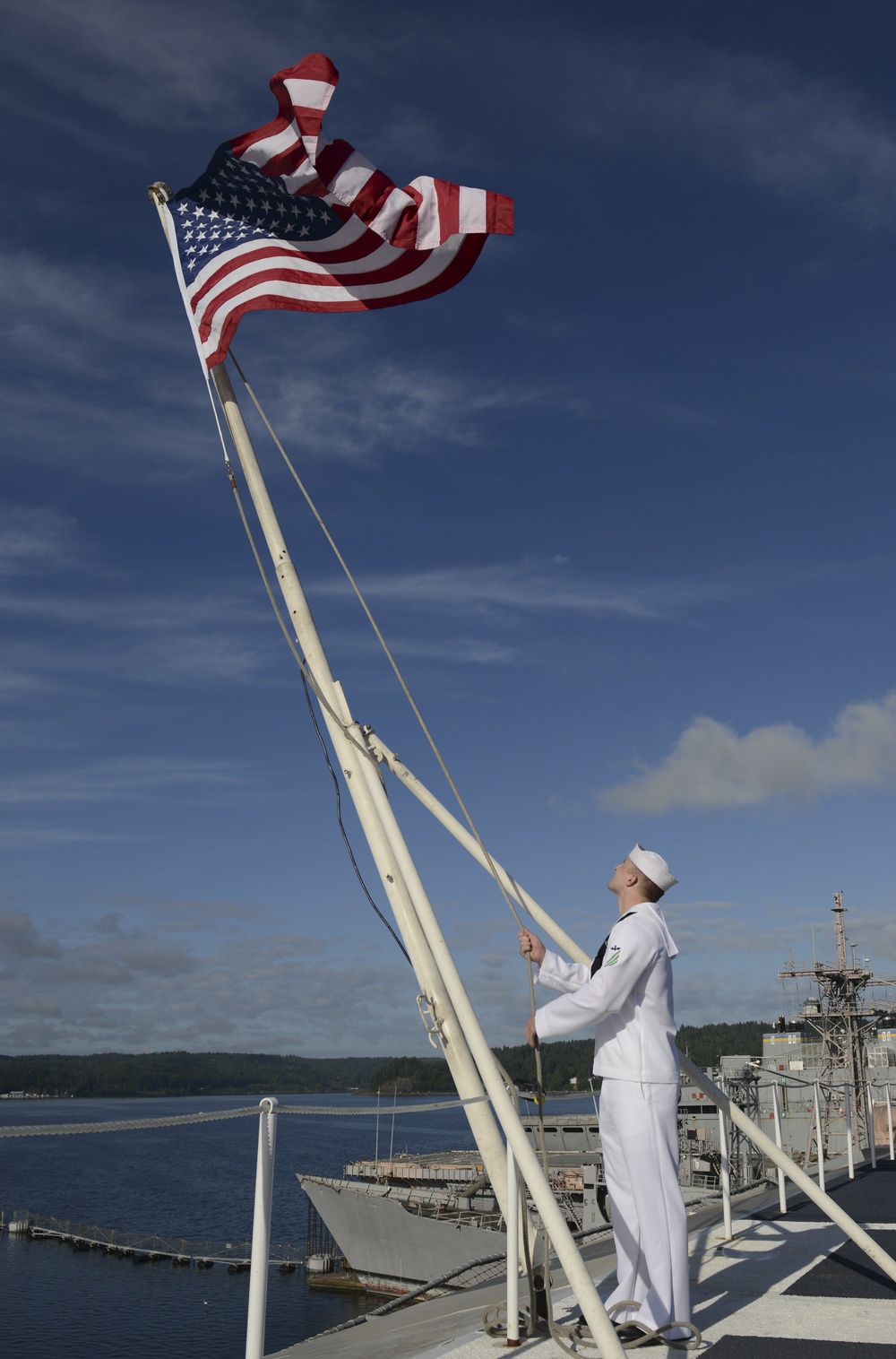Nimitz Sailor Observes Morning Colors