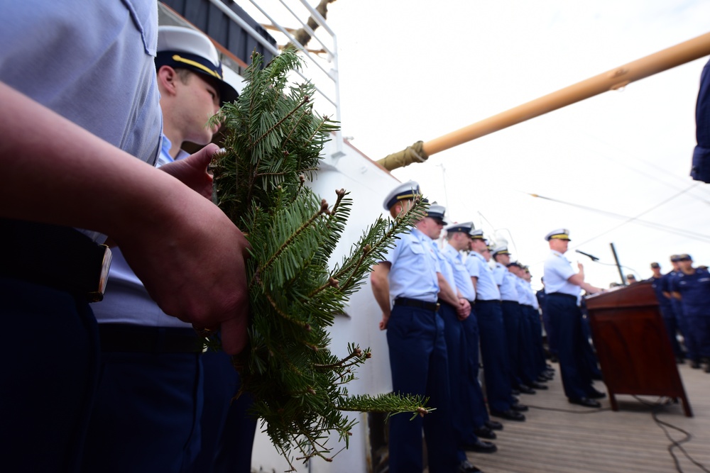 Cadets aboard the U.S. Coast Guard Tall Ship Eagle hold a wreath during a D-DAY commemoration ceremony
