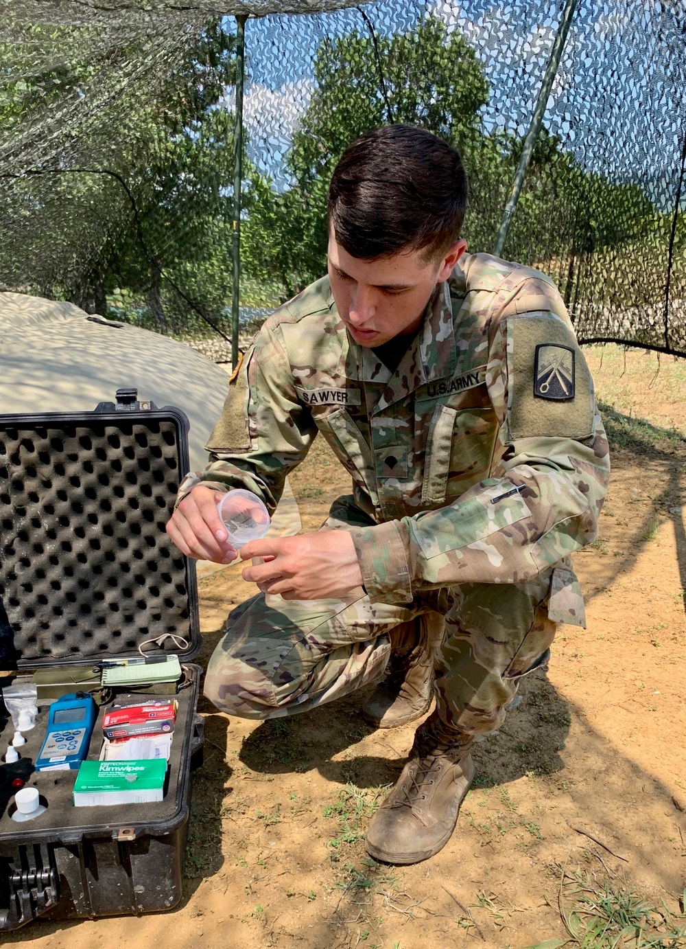 Soldier tests purified water to distribute to units participating in Strike Back 19
