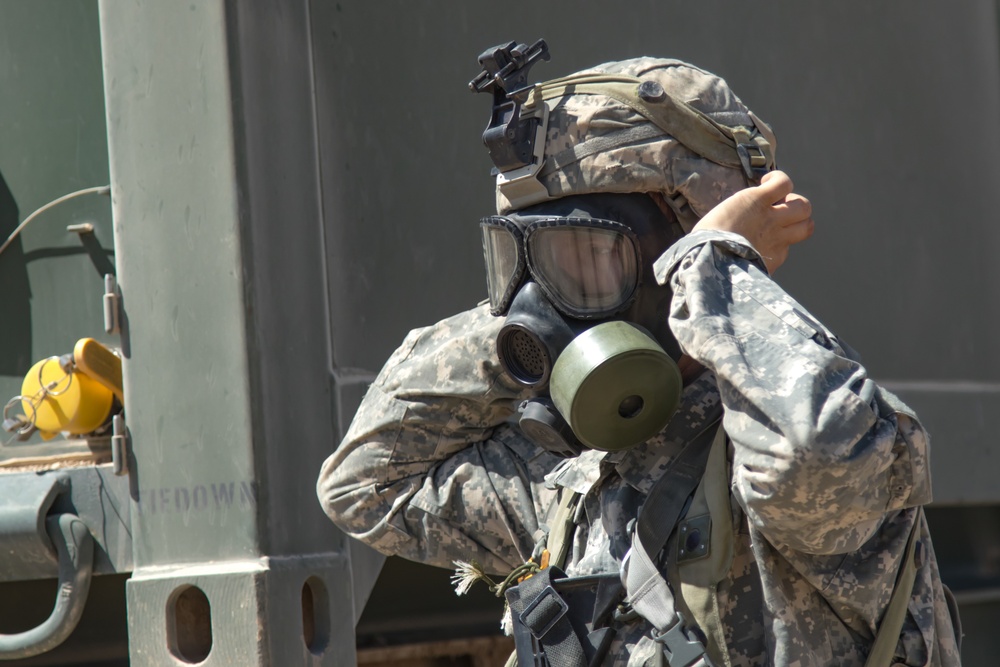 Idaho Army National Guard Soldiers from the 145th Brigade Support Battalion, 116th Cavalry Brigade Combat Team, don protective masks