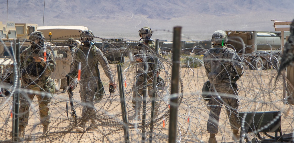 Soldiers from 145th Brigade Support Battalion conduct troop movement under gas attack