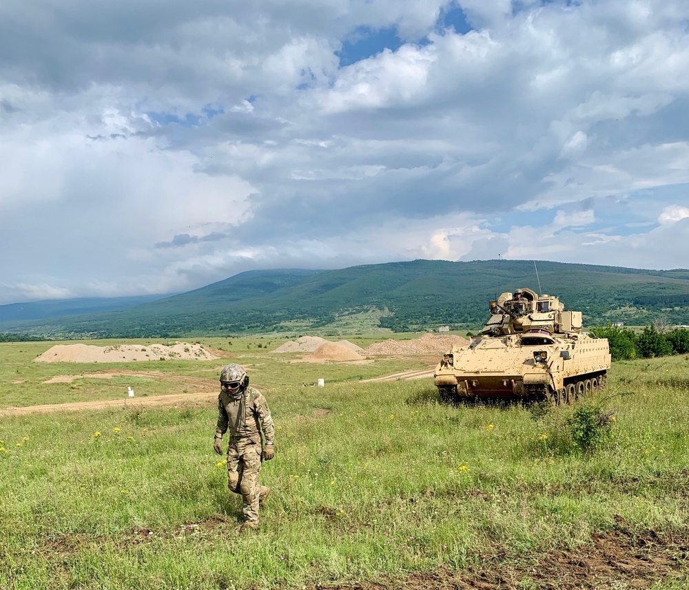 Soldier ground guides Bradley Fighting Vehicle during Strike Back 19