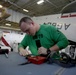 Sailors replace rotor blade on helicopter