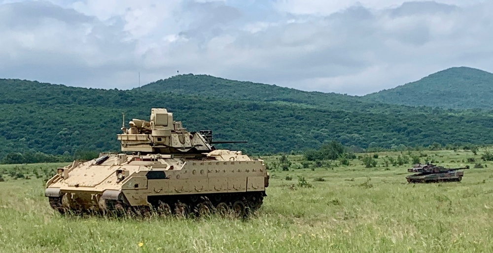 U.S. Army Bradley Fighting Vehicle and Bulgarian Land Forces T-72 Tank travel to battle positions during Strike Back 19