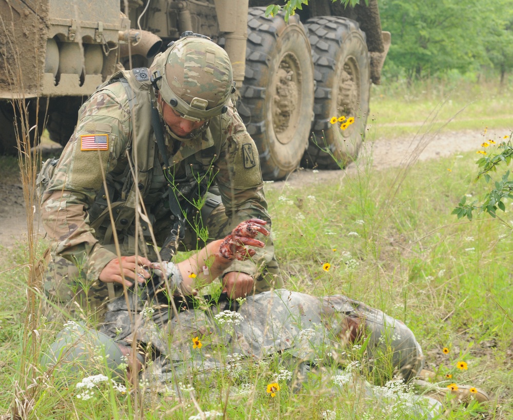 Oklahoma National Guards Soldier performs first aid at Fort Chaffee, Arkansas