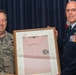 Chief Master Sgt. William Schy presents the &quot;pink polo&quot; to Chief Master Sgt. Terrance Hunt