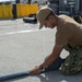 USS Asheville Sailors performs maintenance