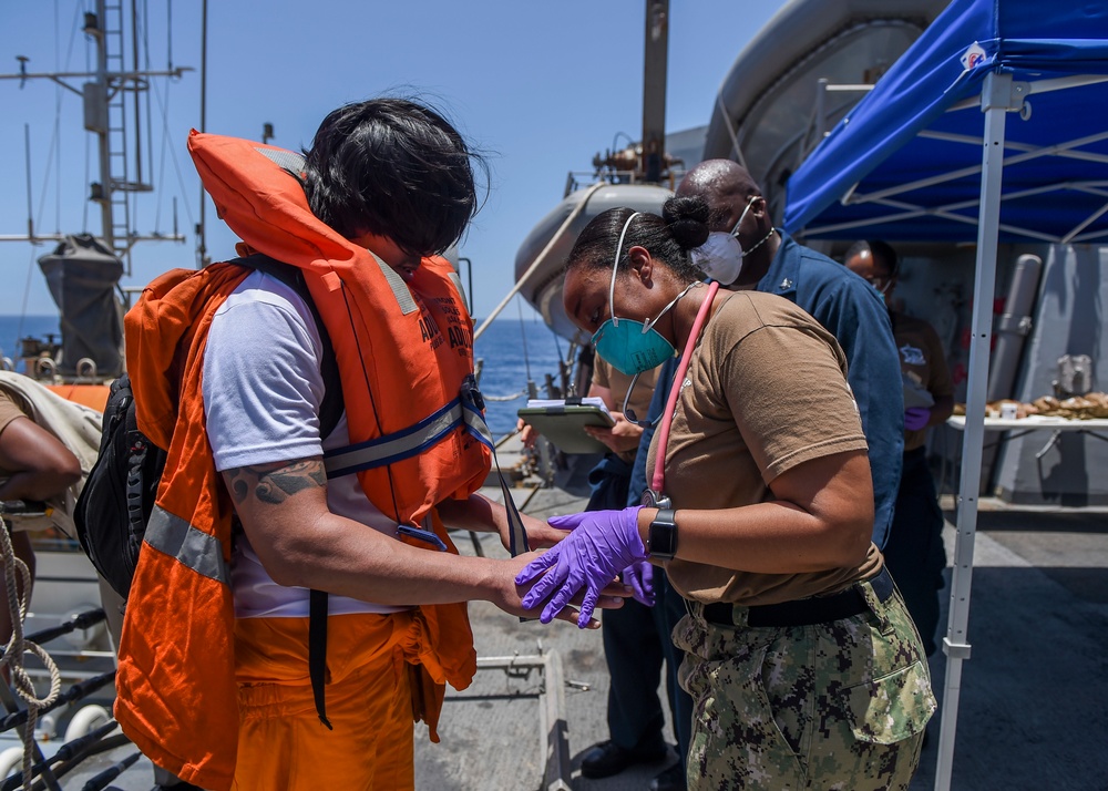Sailors aboard the Arleigh Burke-class guided-missile destroyer USS Bainbridge (DDG 96) render aid to the crew of the M/V Kokuka Courageous
