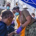 s aboard the Arleigh Burke-class guided-missile destroyer USS Bainbridge (DDG 96) render aid to the crew of the M/V Kokuka Courageous