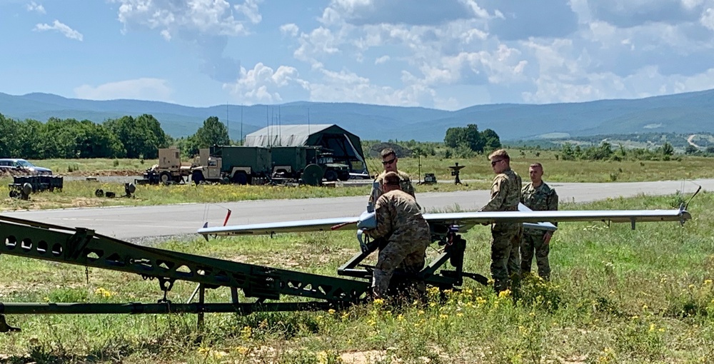 Soldiers loads a RQ-to 7B V2 Shadow Unmanned Aircraft to a high powered launcher