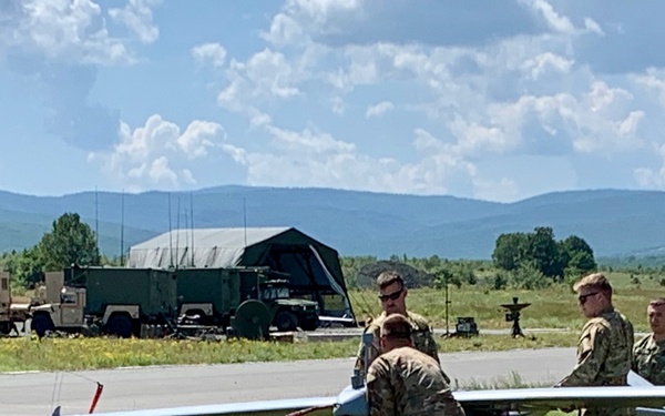 Soldiers loads a RQ-to 7B V2 Shadow Unmanned Aircraft to a high powered launcher