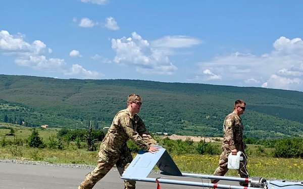 Soldiers push Shadow unmanned aircraft to high powered launcher