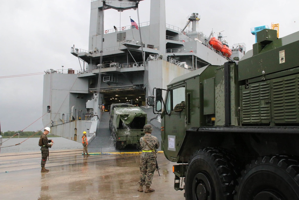 Soldiers and Marines load equipment aboard the U.S.N.S. Watkins (T-AKR 315) while moored at Wharf Alpha on Joint Base Charleston, South Carolina