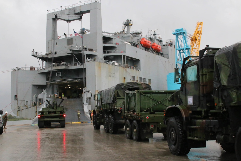 Soldiers and Marines load equipment aboard the U.S.N.S. Watkins (T-AKR 315) while moored at Wharf Alpha on Joint Base Charleston, South Carolina