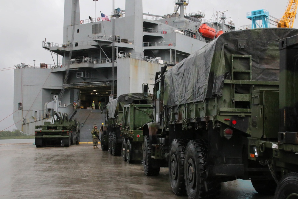 Soldiers and Marines load equipment aboard the U.S.N.S. Watkins (T-AKR 315) while moored at Wharf Alpha on Joint Base Charleston, South Carolina