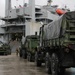 Soldiers and Marines load equipment aboard the U.S.N.S. Watkins (T-AKR 315) while moored at Wharf Alpha on Joint Base Charleston, South Carolina