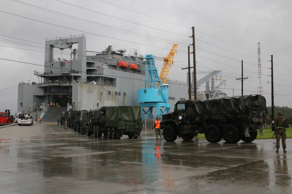 Soldiers and Marines load equipment aboard the U.S.N.S. Watkins (T-AKR 315) while moored at Wharf Alpha on Joint Base Charleston, South Carolina